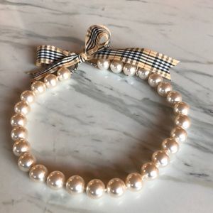 Pearl necklace with plaid tie closure